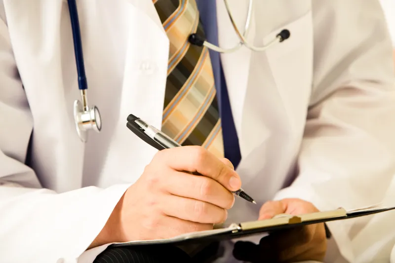 a doctor writing work restrictions.